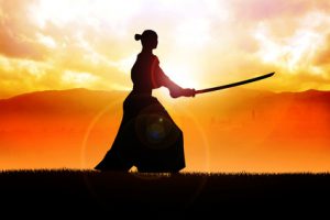 Silhouette of a samurai posing during sunset