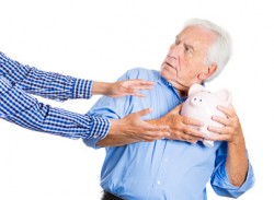 Senior man protecting piggy bank, savings from being stolen